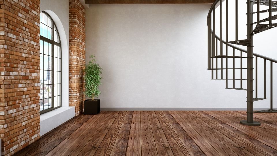 Egy tágas loft lakás belső tere, nagy ablakokkal és spirál lépcsővel.